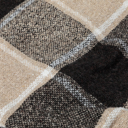 Close-up of a textured, plaid fabric in earthy tones of brown and cream.