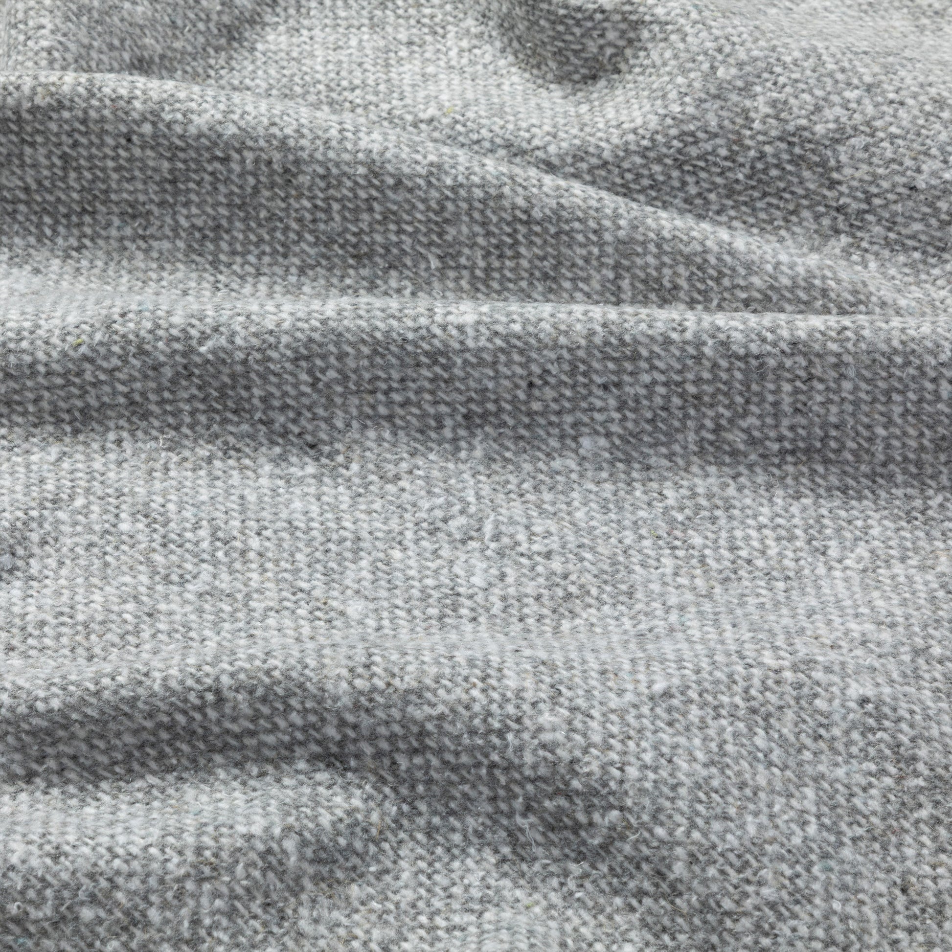 Close-up of soft, textured gray fabric with subtle variations in color.