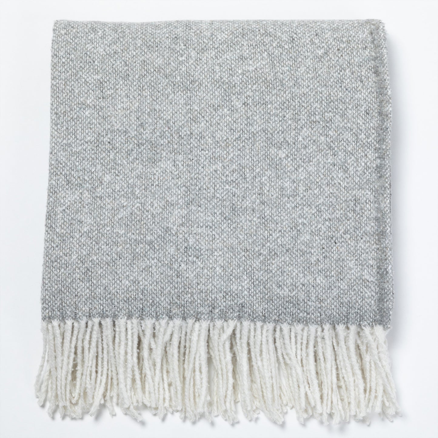Gray woven throw blanket with white fringes, perfect for cozying up.