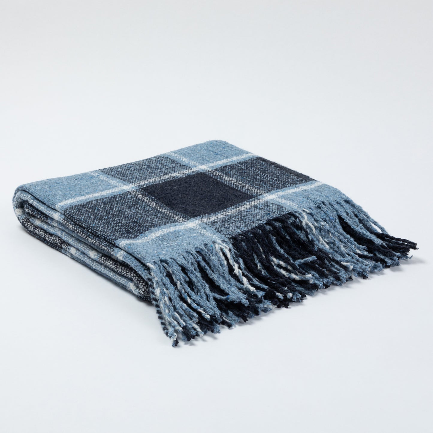 Cozy blue plaid throw blanket with fringed edges, perfect for warmth and style.