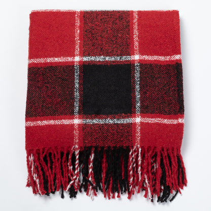 A red and black plaid fringed blanket with white accent lines, laid flat against a white background.