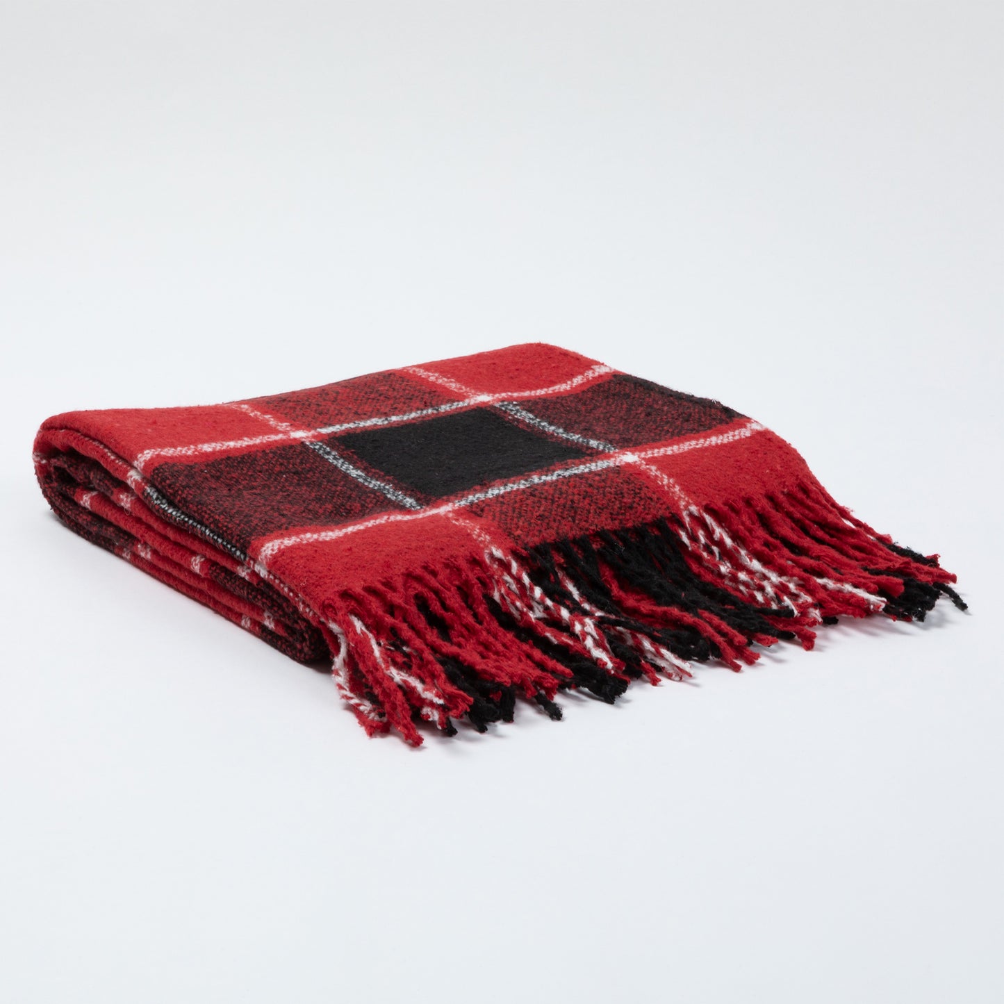 Red and black plaid blanket with fringe edges, neatly folded on a light background.