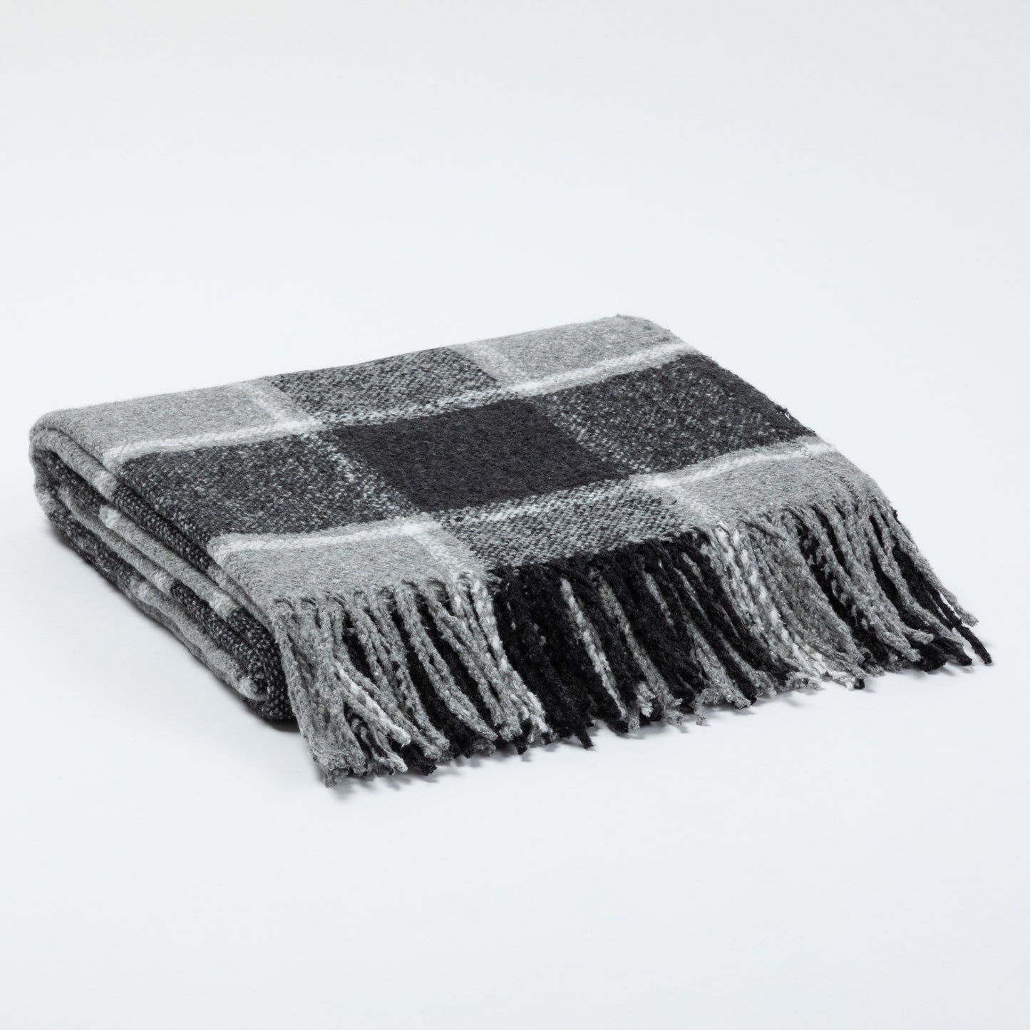 Gray plaid throw blanket with fringed edges, folded neatly on a flat surface.