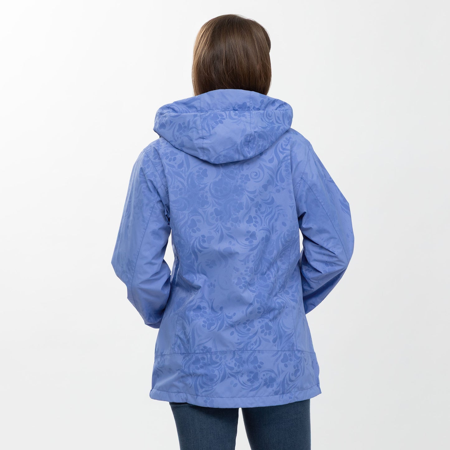 Person wearing a periwinkle paw patterned raincoat on a white background