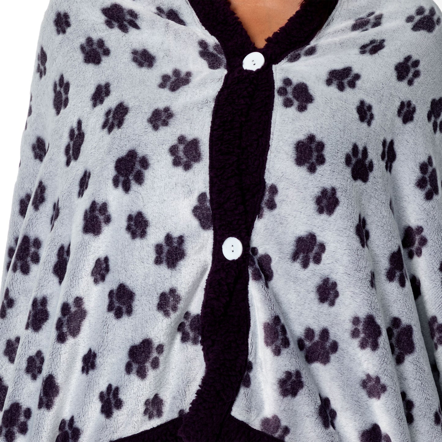Person wearing a paw print patterned wearable blanket with two front buttons.
