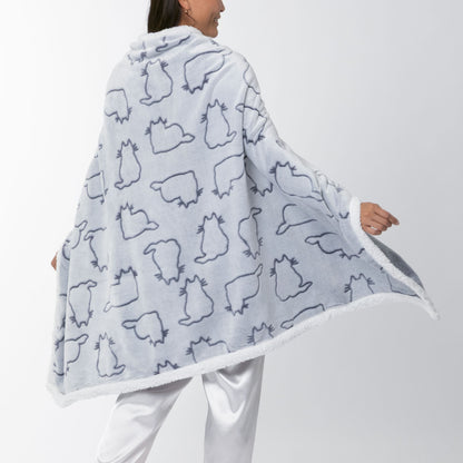 Person wrapped in a gray blanket hoodie with white trim, wearing white pajamas, with a white background.