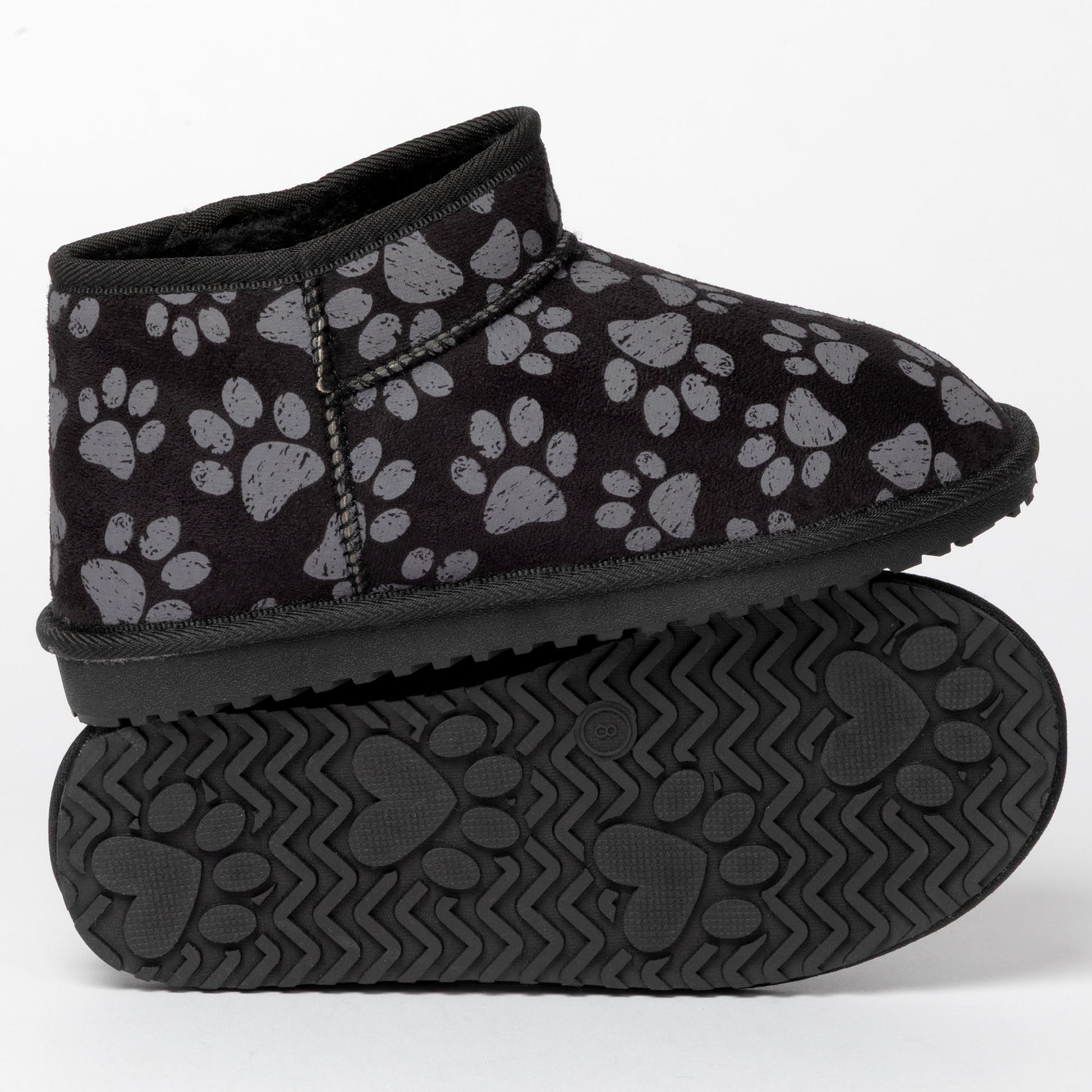 Black slip-on shoes with paw print pattern on a white background