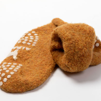A pair of brown felted wool slippers with white grip dots and a white star design on the sole, photographed on a clean white background.
