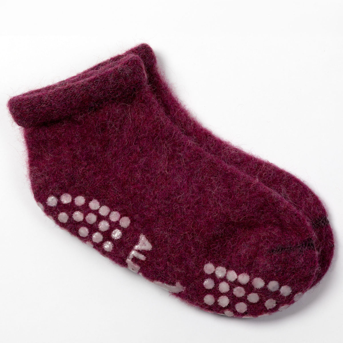 A pair of dark burgundy wool ankle socks with white silicone grip dots on the sole, shown on a clean white background.