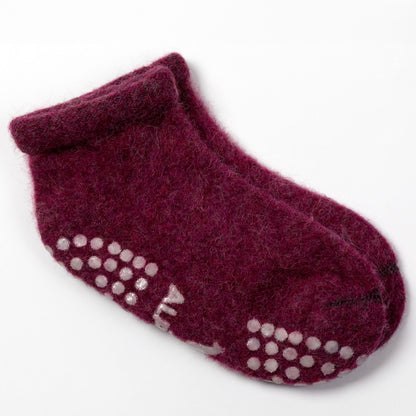 A pair of dark burgundy wool ankle socks with white silicone grip dots on the sole, shown on a clean white background.