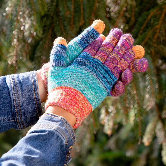 A pair of Rainbow Delight Touch Screen Gloves being worn outdoors, with orange accents on the thumb and index finger for touchscreen capability.