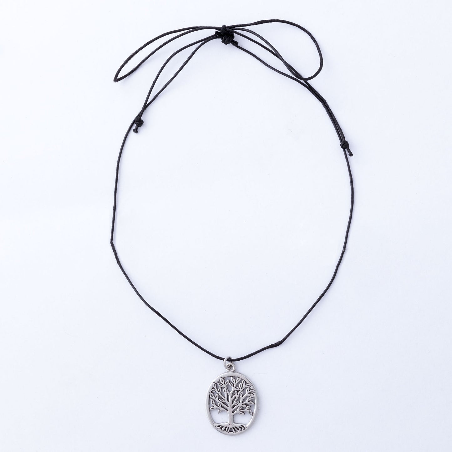 Black cord necklace with a silver tree pendant on a white background