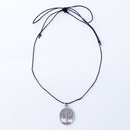 Black cord necklace with a silver tree pendant on a white background