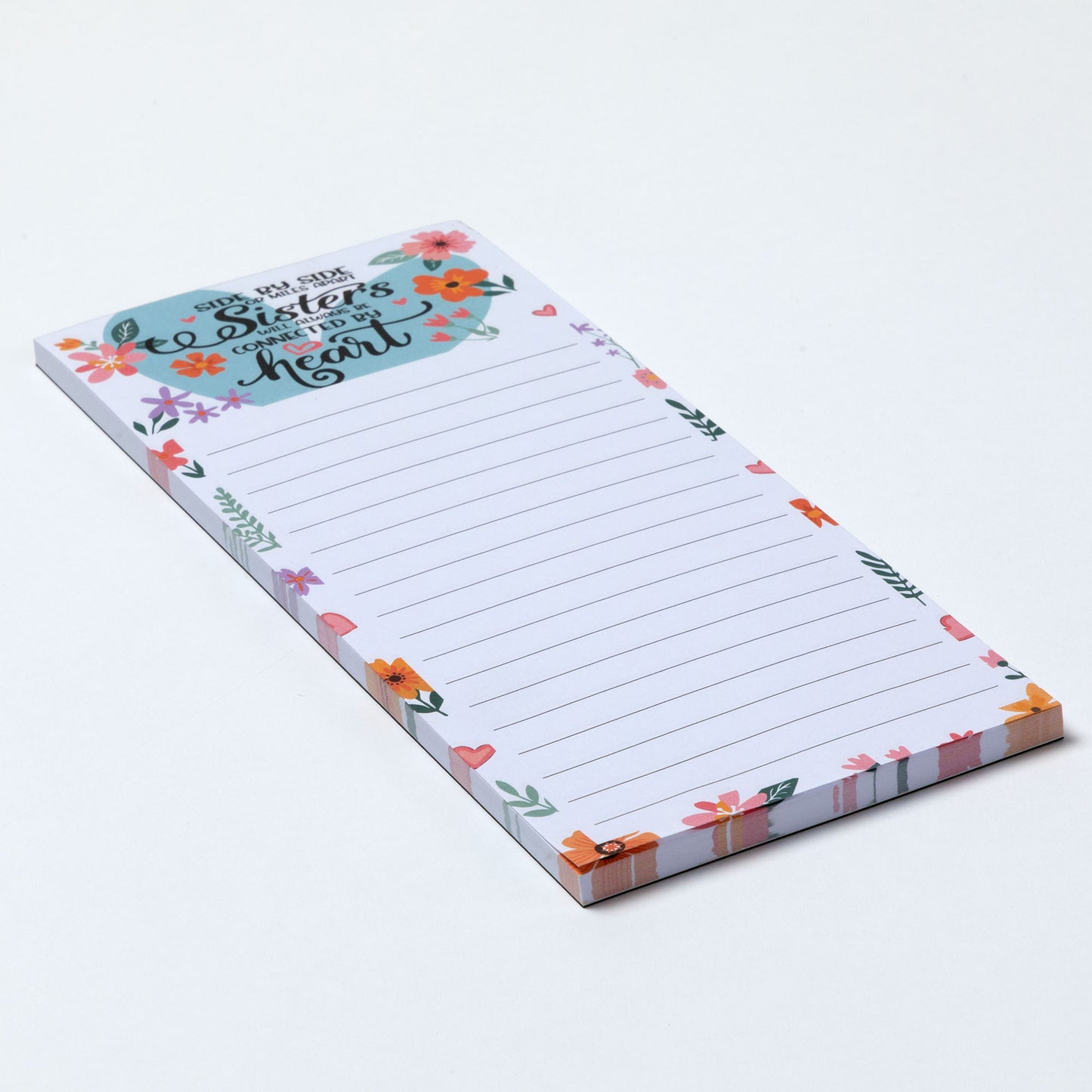 Notepad with floral design and inspirational message about sisterhood on a white background.