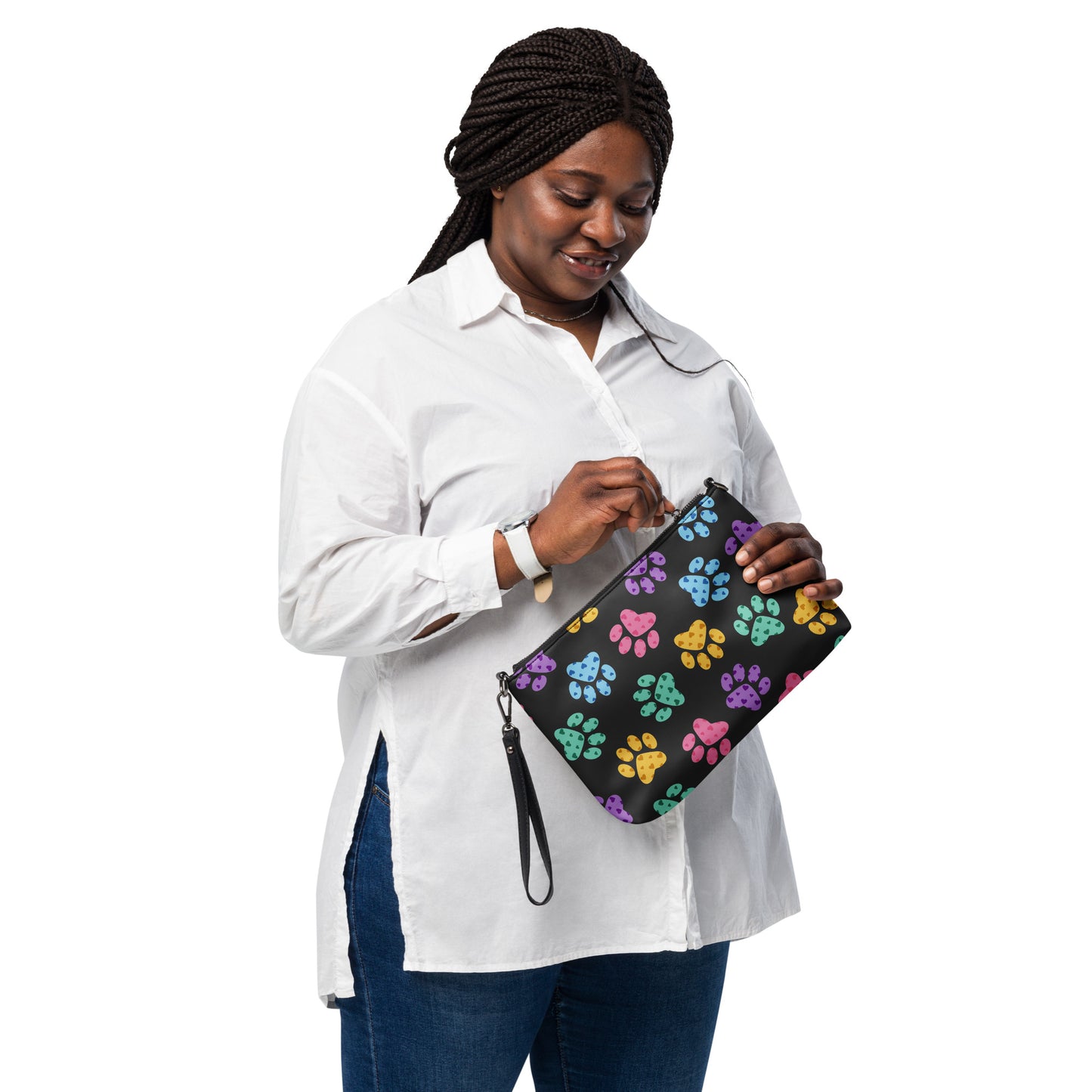 Woman holding a black clutch with paw print pattern on a white background