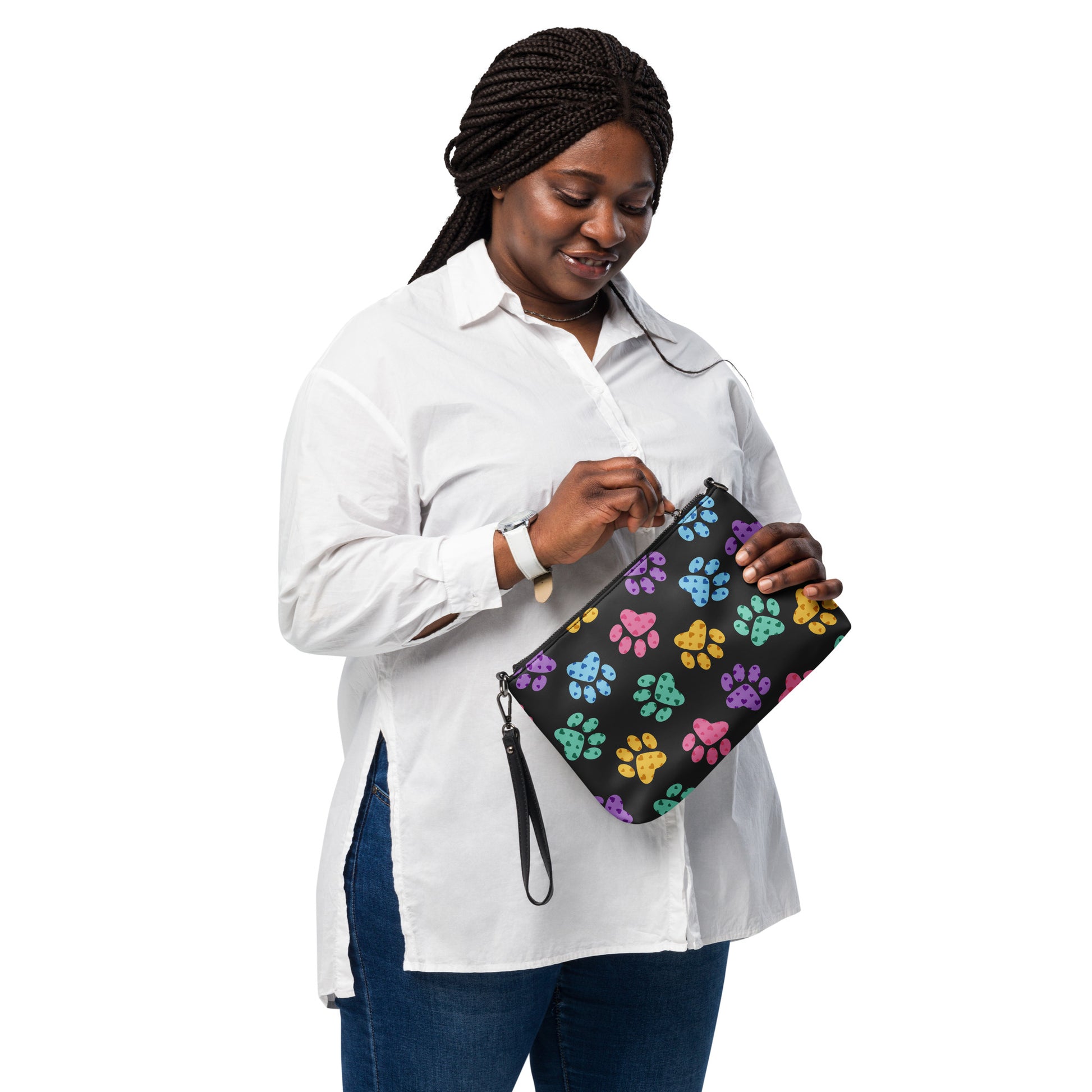Woman holding a black clutch with paw print pattern on a white background