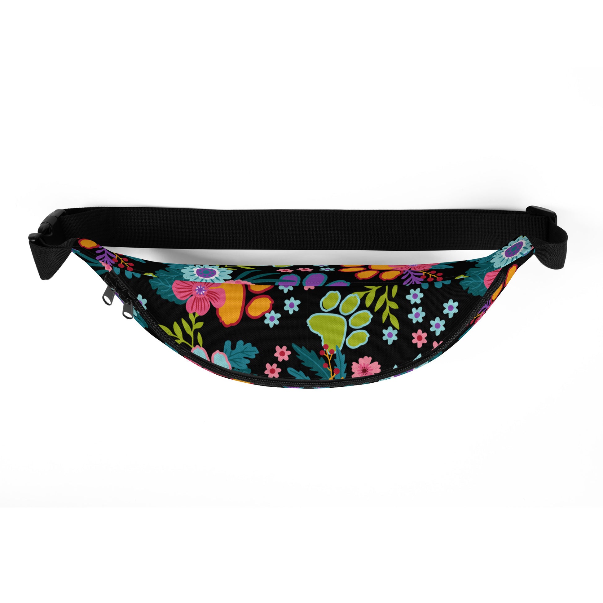 Floral Paw print pattern with a black background on a fanny pack with a black strap. top view.