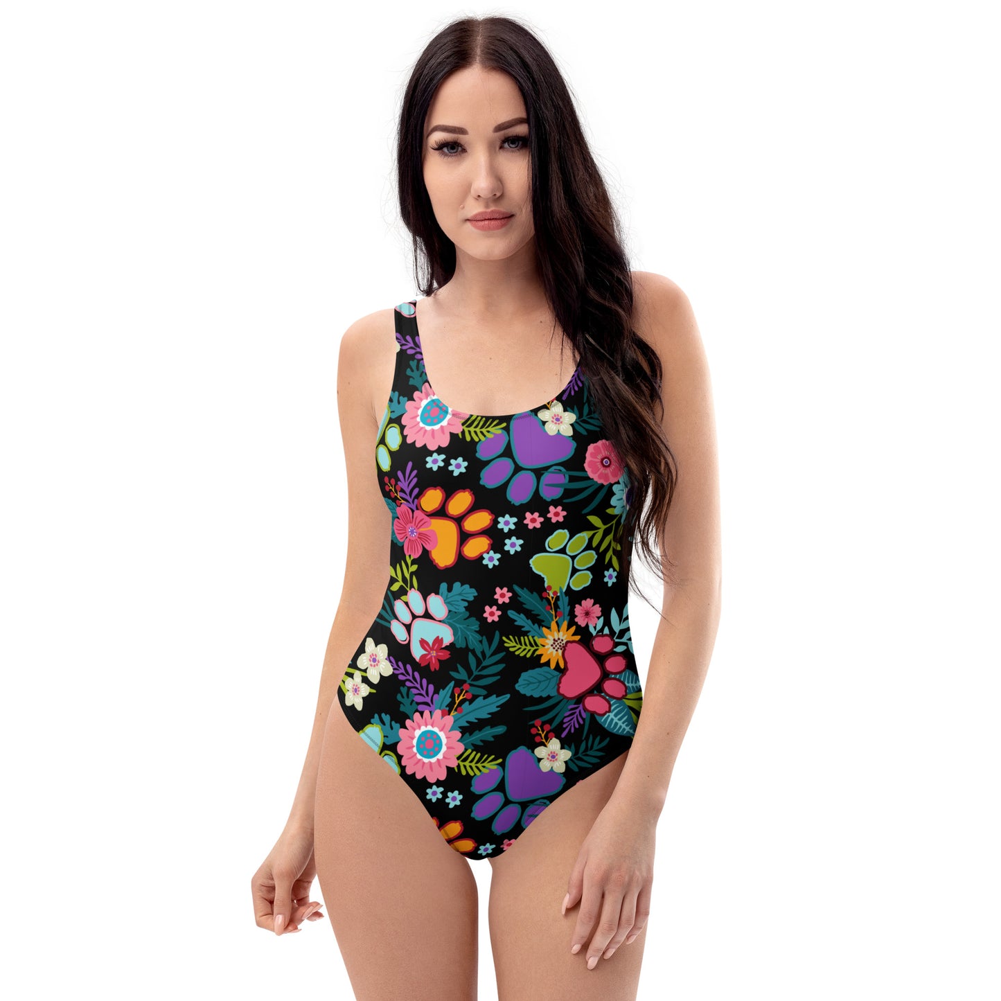 Front view of Woman wearing one piece swimsuit with paw prints and leaves on it
