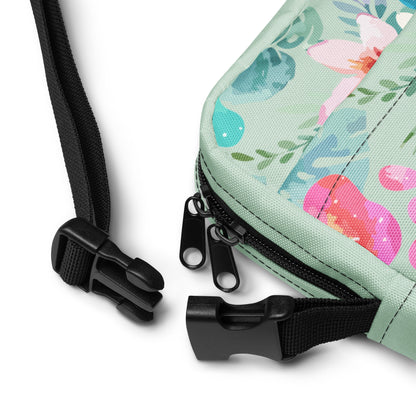 Floral-patterned pouch with black strap and zipper on a white background