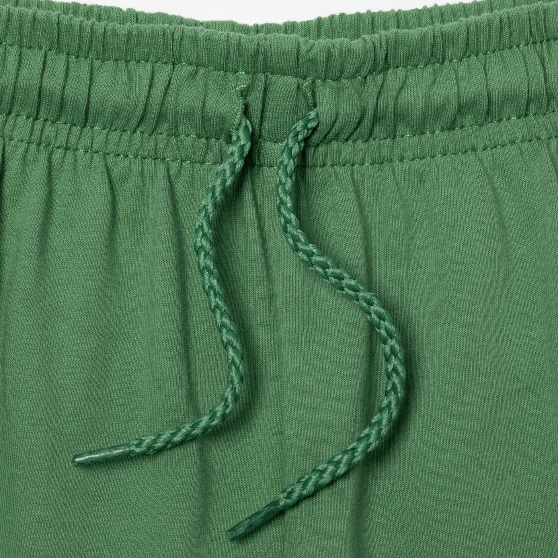 Close-up of green drawstring on a green pair of shorts