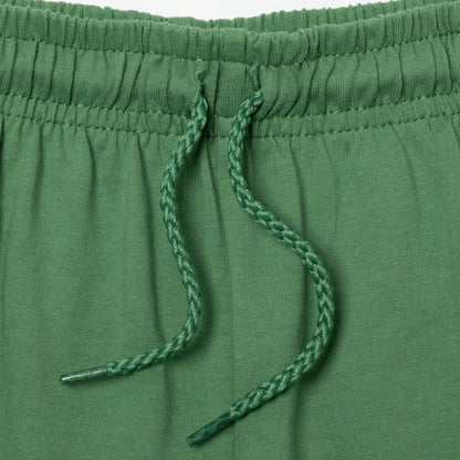 Close-up of green drawstring on a green pair of shorts