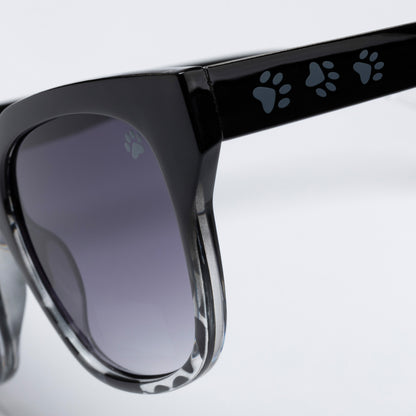 Black sunglasses with paw print design on arms against a light gray background
