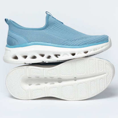 Light blue slip-on shoes with white soles on a light gray background