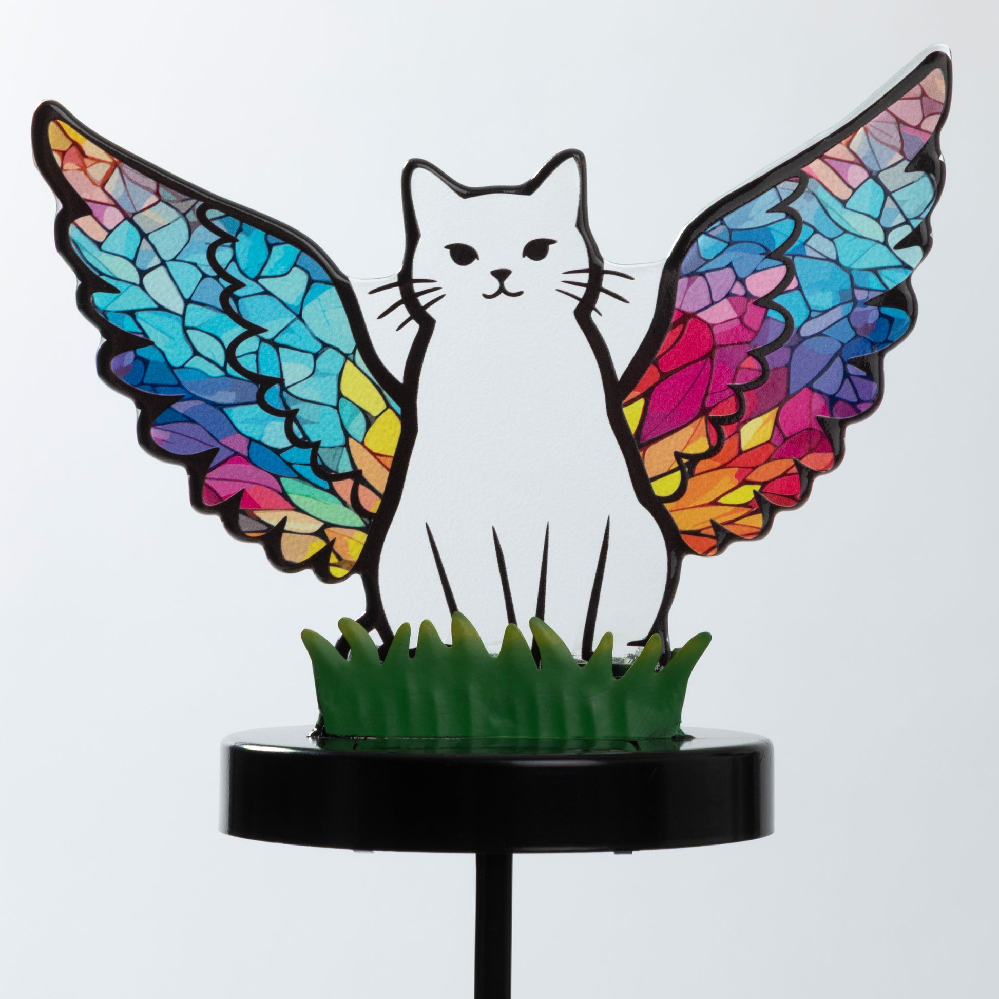 Cat silhouette with mosaic angel wings on a garden stake, against a white background.