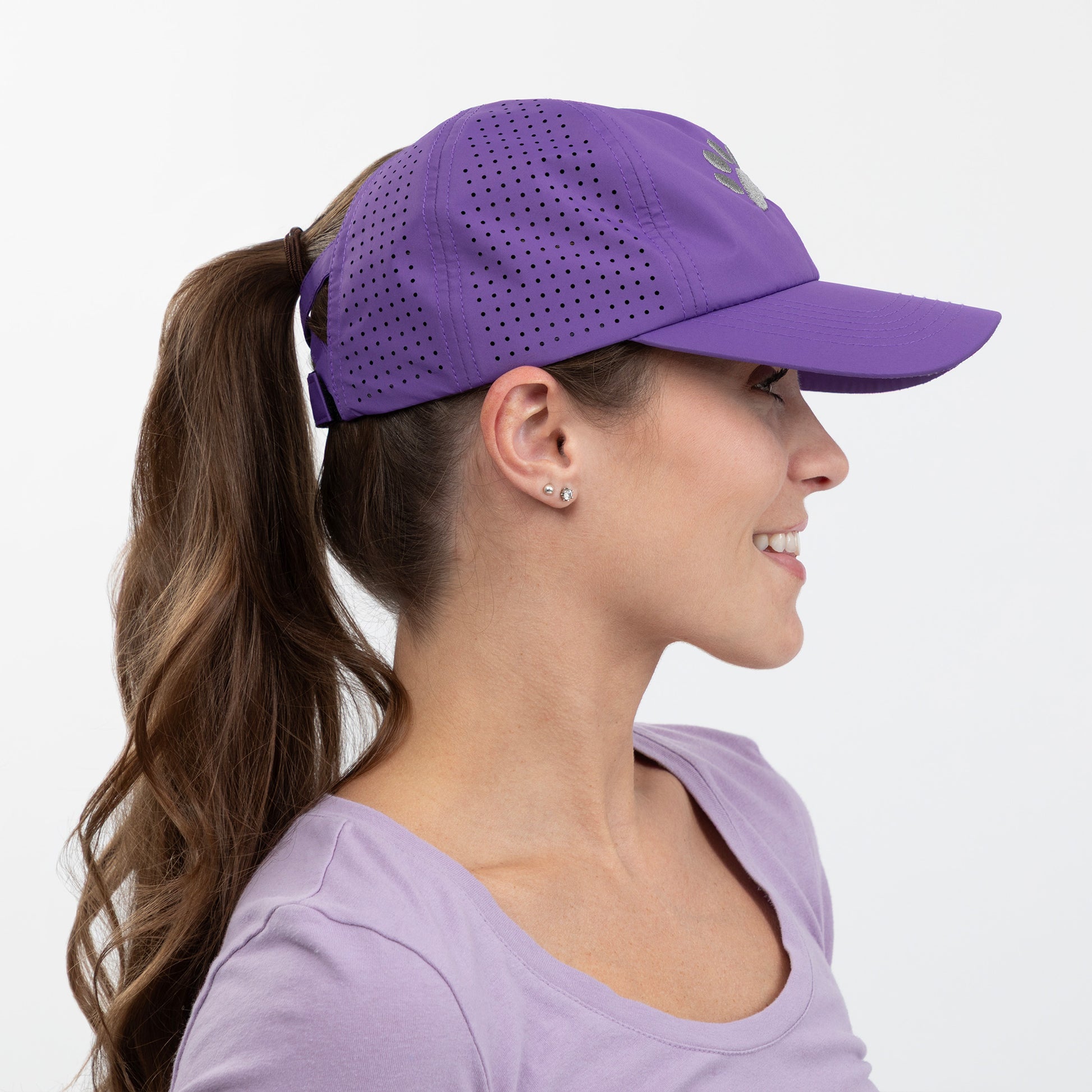 Woman wearing a purple cap and shirt on a white background