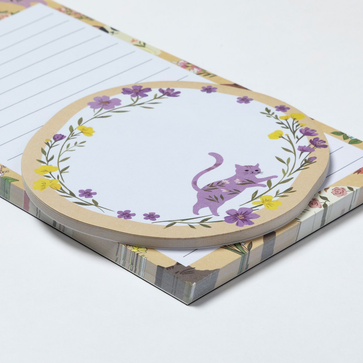 Notepad with a purple cat illustration on a floral border