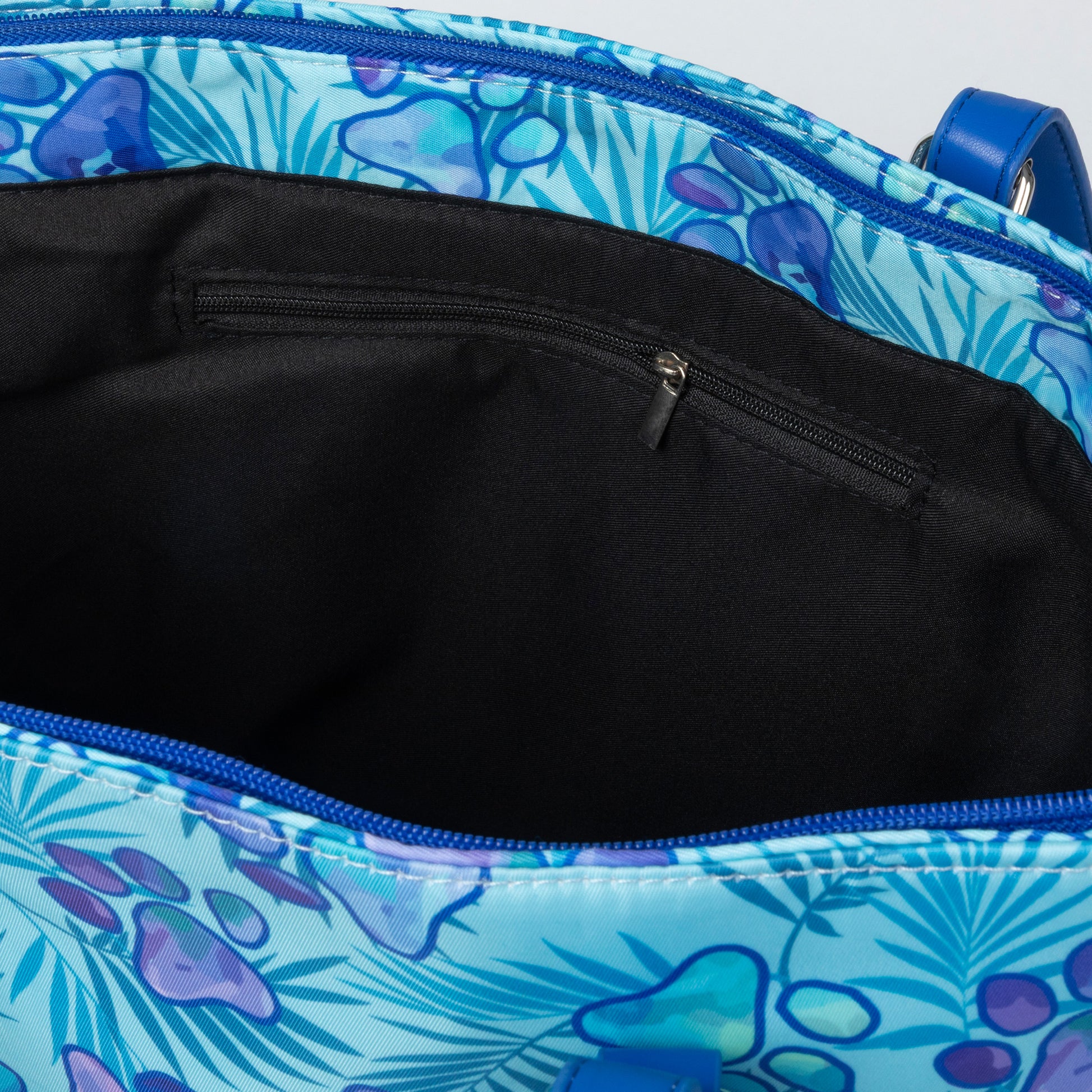Blue paw print floral-patterned bag with a black interior