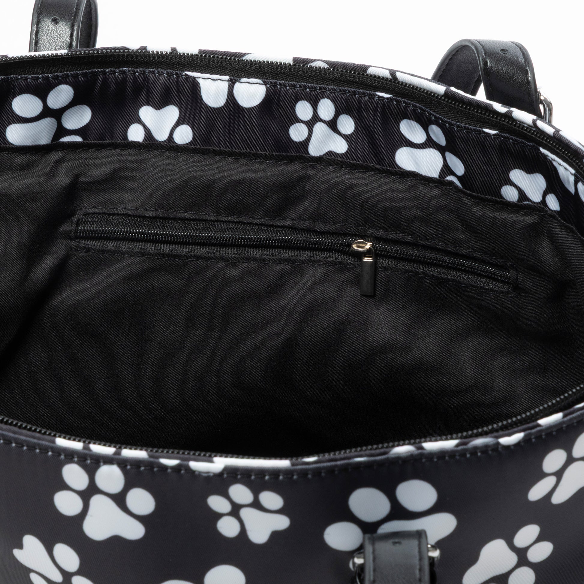 Black bag with white paw prints inside, showing a zipper and interior.