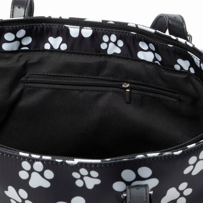 Black bag with white paw prints inside, showing a zipper and interior.