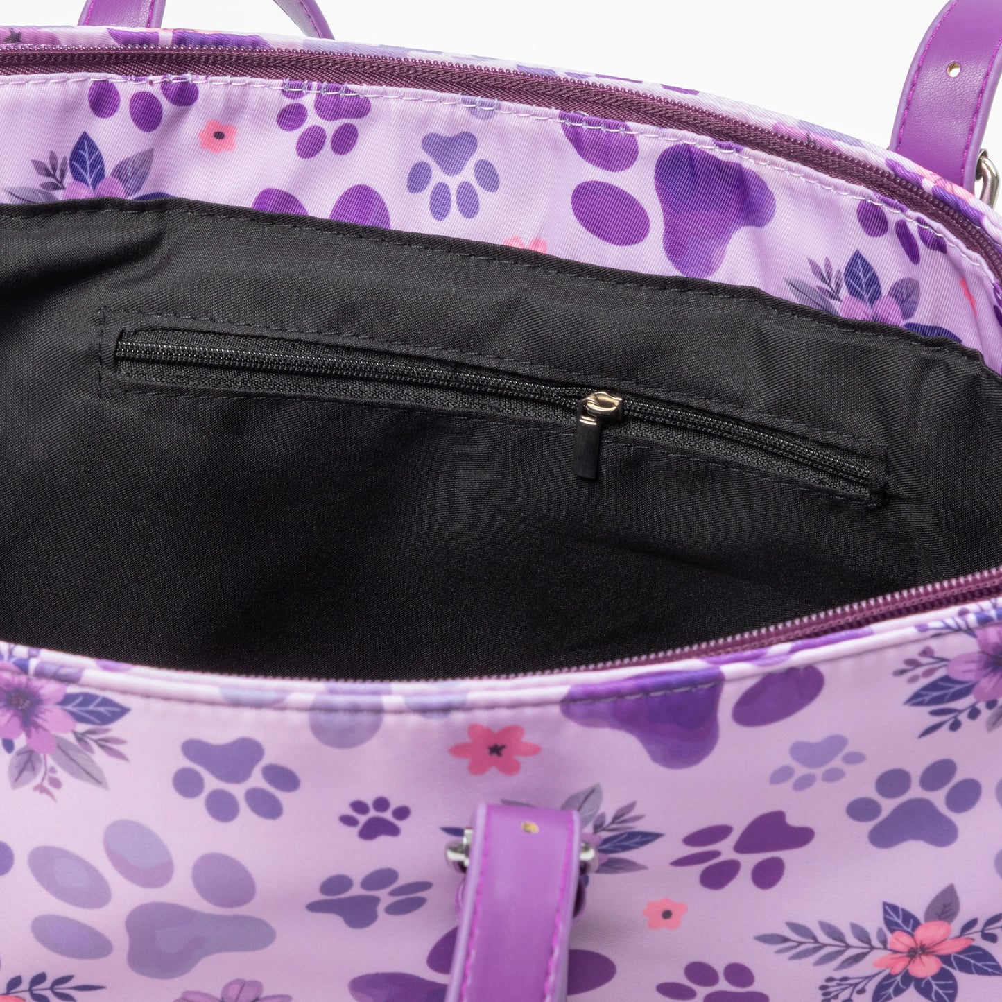 Purple floral and paw print bag with a black interior pocket.