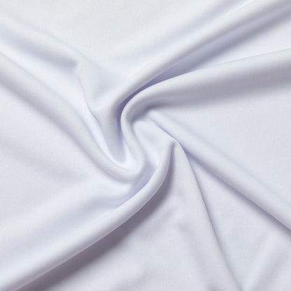 A close-up of draped white fabric with soft folds and a smooth texture filling the frame.