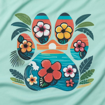 A close-up of a mint green fabric surface featuring a colorful tropical paw print graphic with hibiscus flowers and palm leaves.