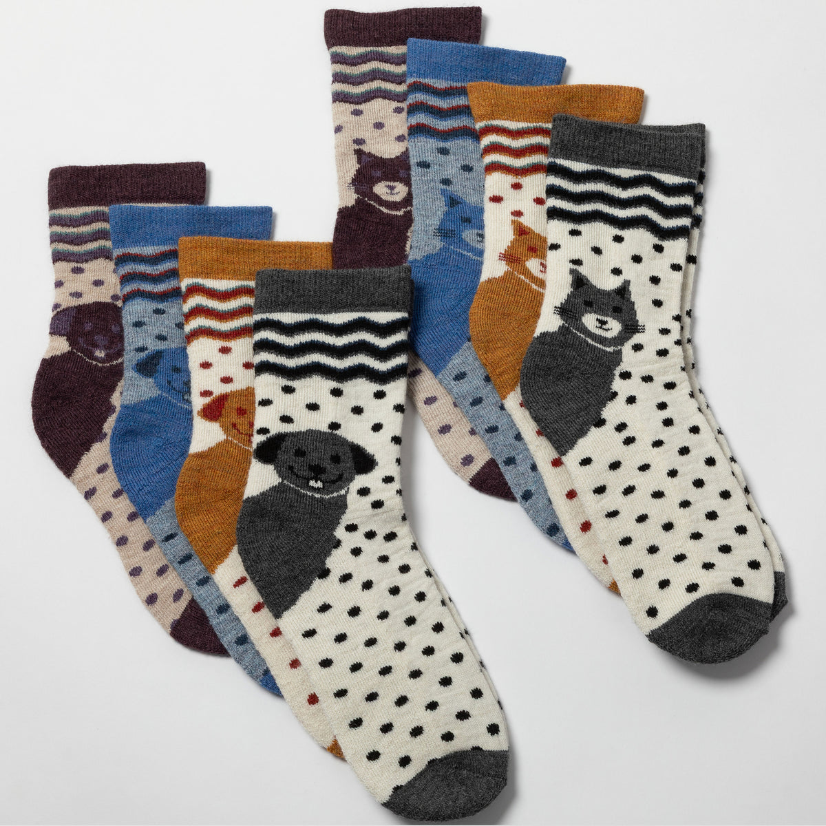 A set of six children's crew socks arranged in two overlapping rows on a light gray background. The socks feature playful animal prints including bears, dogs, cats, and a rabbit, with various colorful patterns such as polka dots, stripes, and wavy lines.