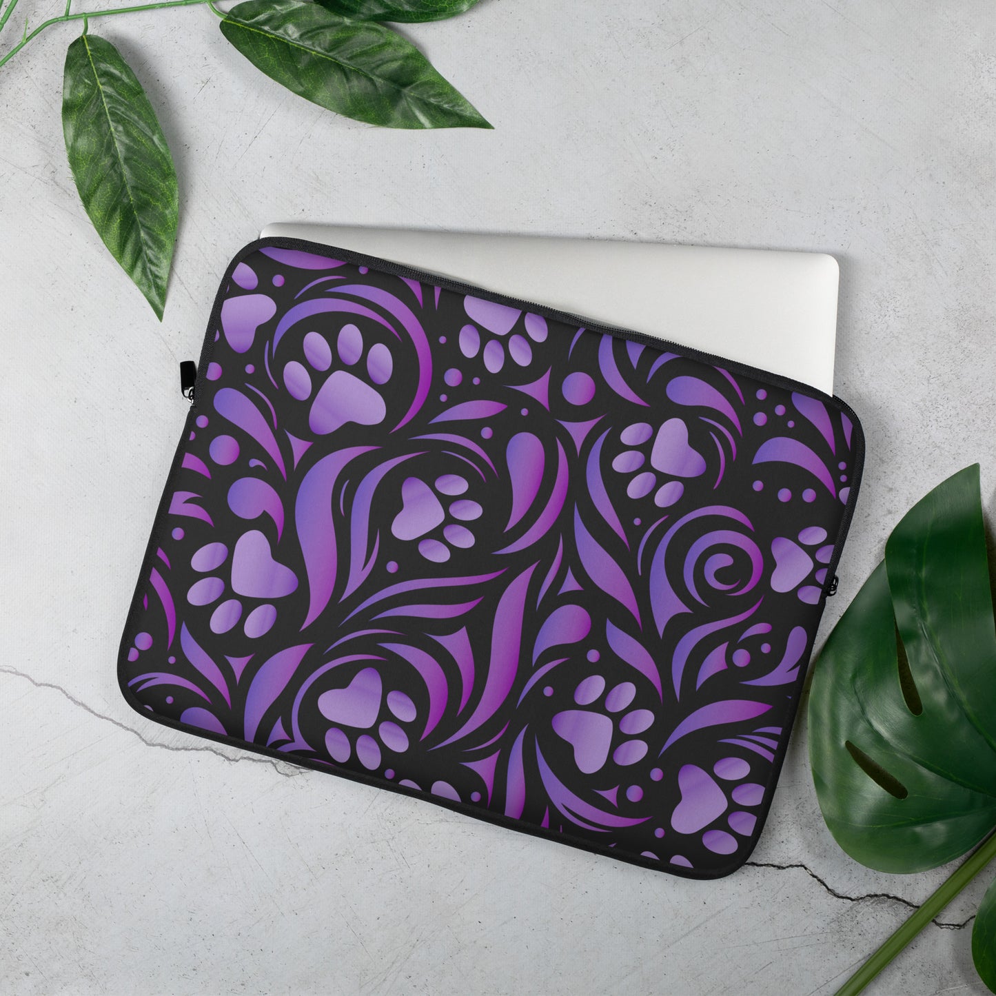 Laptop Sleeve bag designed with purple paw prints and swirls with black accents. 