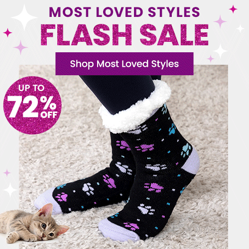 Most Loved Styles Flash Sale from The Animal Rescue Site and GreaterGood, featuring cozy black paw-print sherpa socks with white cuffs, winter comfort accessories shown beside a resting cat.