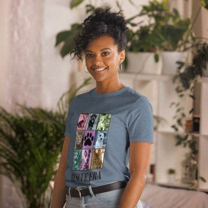 Female model wearing a Blue t-shirt with a grid of dog and cat images and 'RESCUE ERA' text  with plants in the background