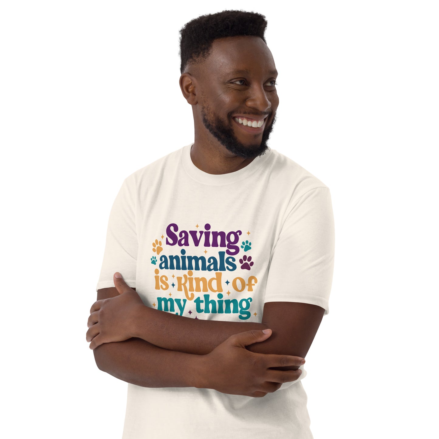 Man in tan shirt that reads Saving Animals is kind of my Thing with several paw print and sparkle images in a purple, yellow and blue font.