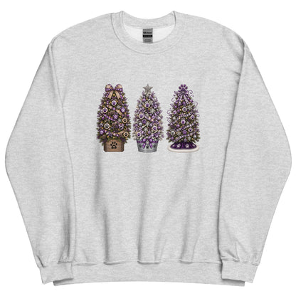 A light heather gray crewneck sweatshirt featuring a graphic print of three decorated Christmas trees in the center. The left tree is brown with a purple bow, the middle tree is silver with a purple star, and the right tree is purple with a white base.