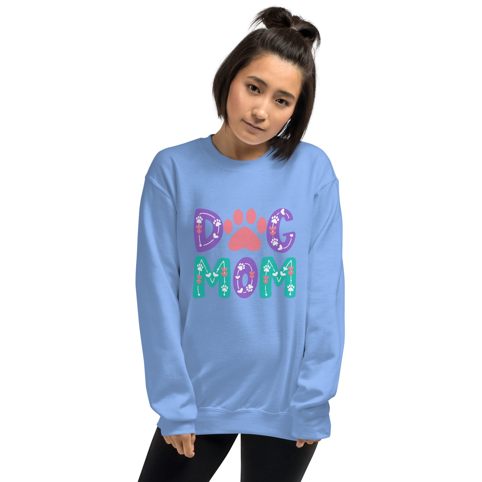Person wearing a blue sweatshirt with 'Dog Mom' text and paw print design on a white background