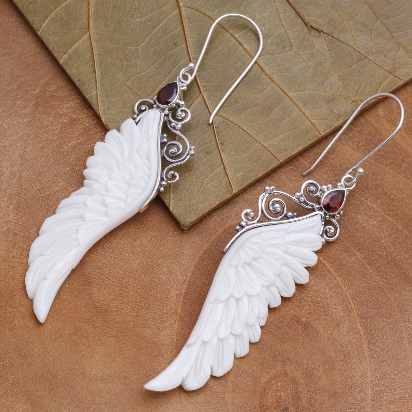 Caressed Wings Garnet and Bone Wing Dangle Earrings from Bali